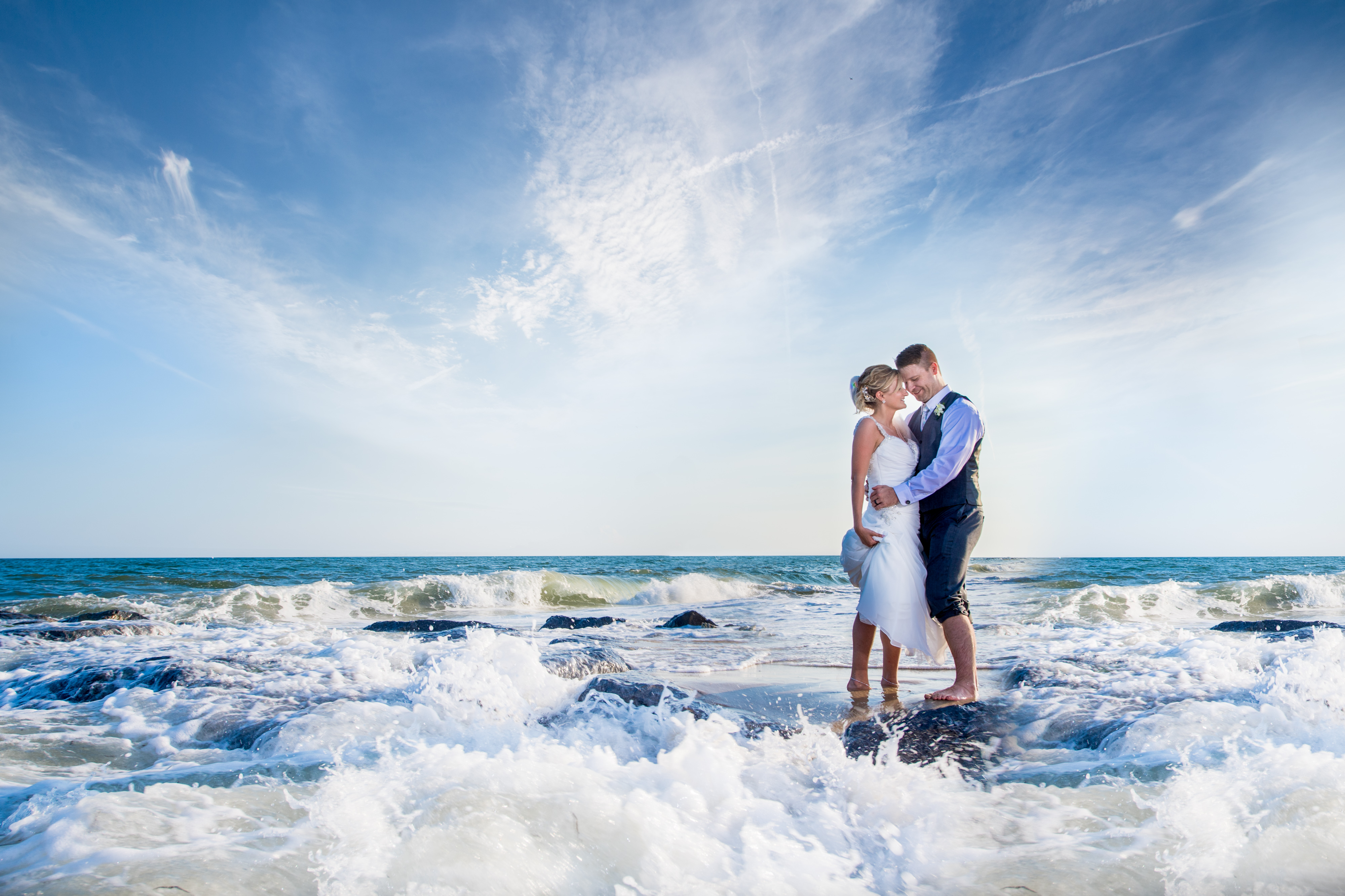 Couple with Waves Crashing at Oceanbleu | Lotus Wedding Photographers