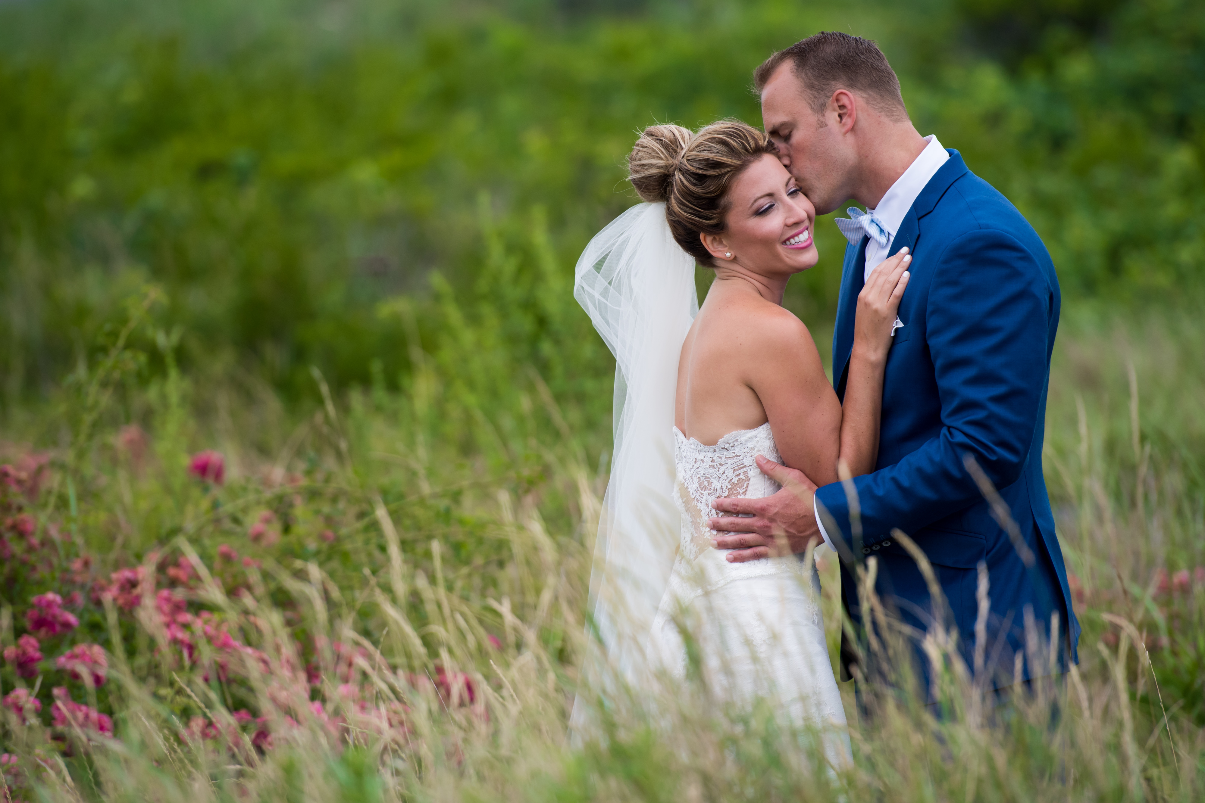Groom Kisses Bride at Lido Beach | Lotus Wedding Photography